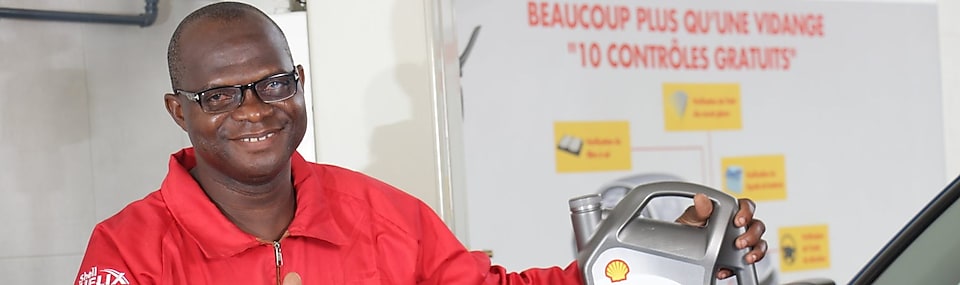 Ivorian mechanic with shell helix motor oil